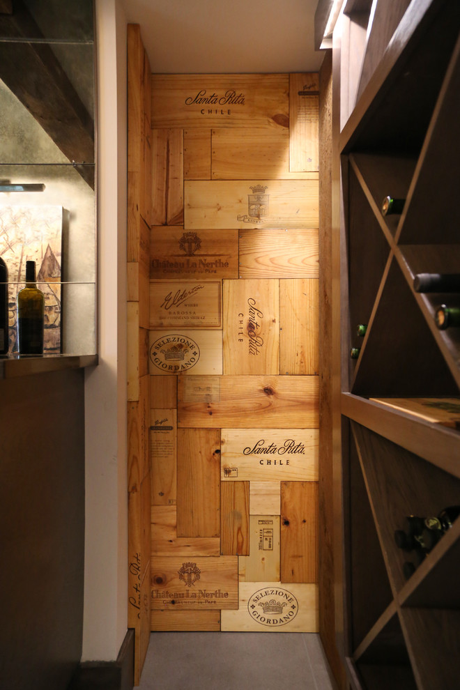 Inspiration for a mid-sized contemporary porcelain tile and gray floor wine cellar remodel in Boise with diamond bins