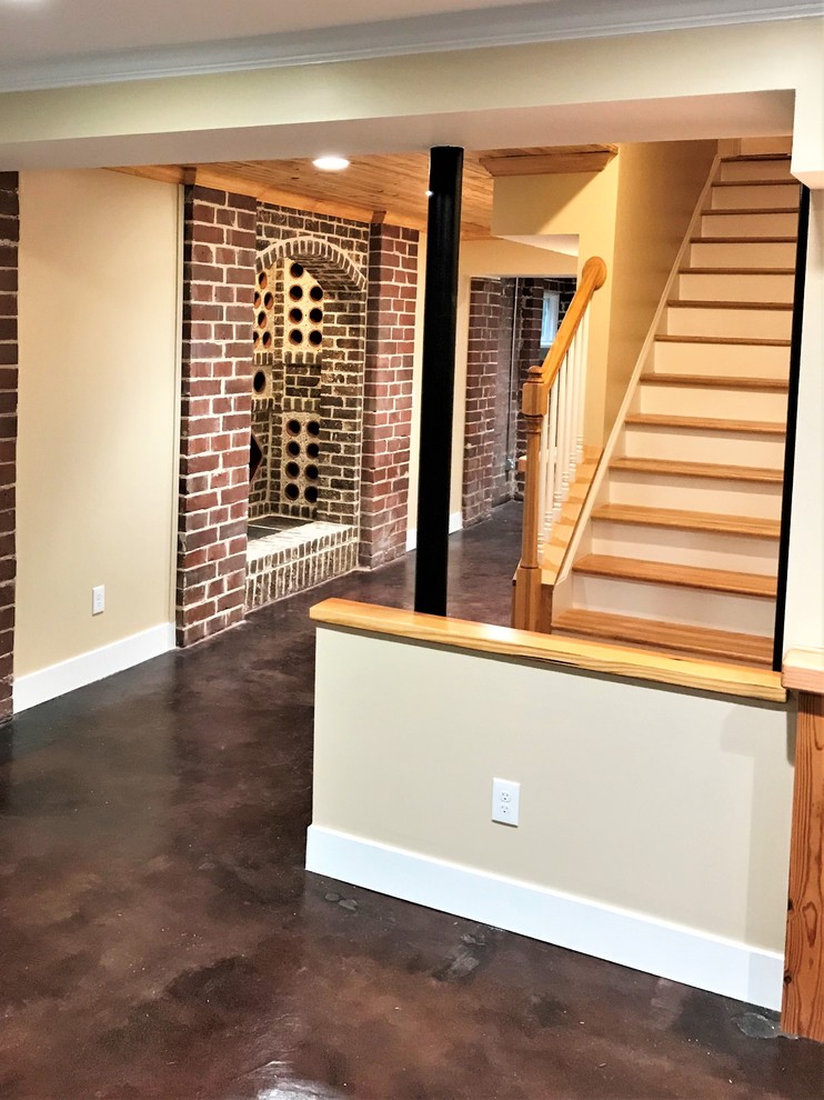 This is an example of a rustic wine cellar in Atlanta with concrete flooring and brown floors.