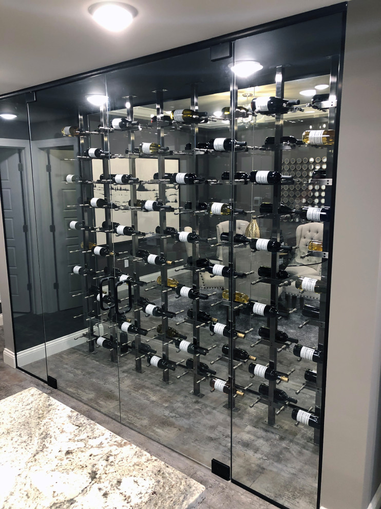 This is an example of a medium sized classic wine cellar in St Louis with display racks.