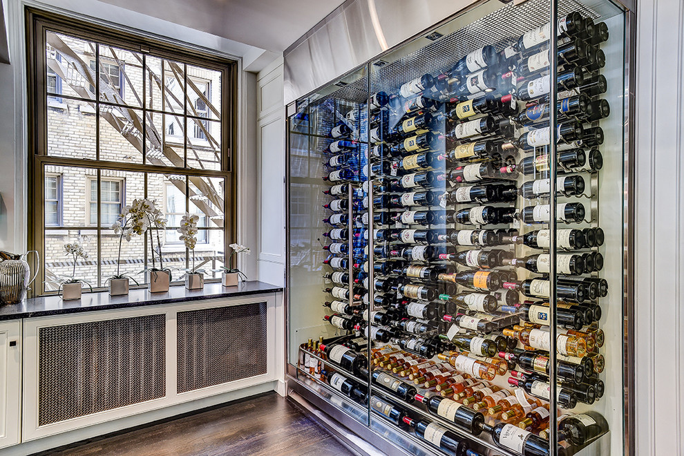 Photo of a contemporary wine cellar in Other with dark hardwood flooring, storage racks and brown floors.