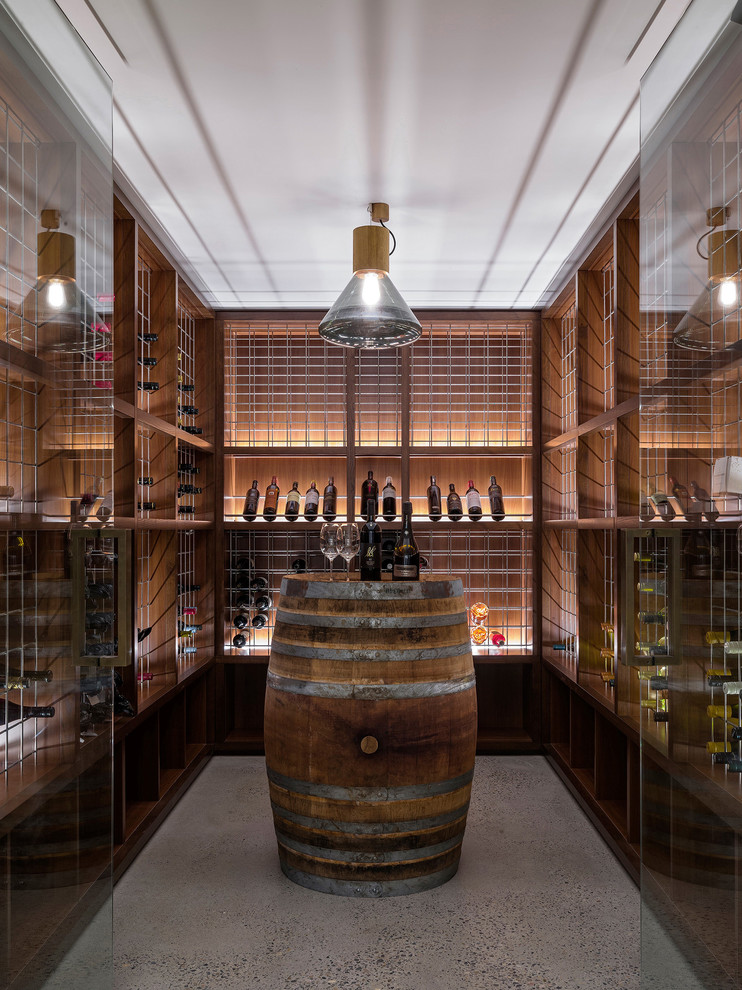 Contemporary wine cellar in Sydney with storage racks and beige floors.