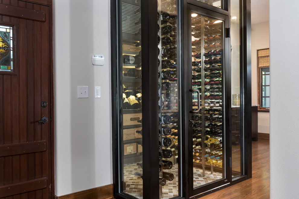 This is an example of a small modern wine cellar in Orlando with marble flooring and multi-coloured floors.