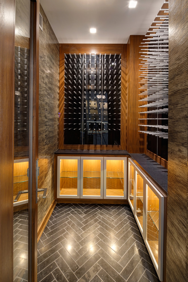 Inspiration for a contemporary slate floor and gray floor wine cellar remodel in Chicago with storage racks