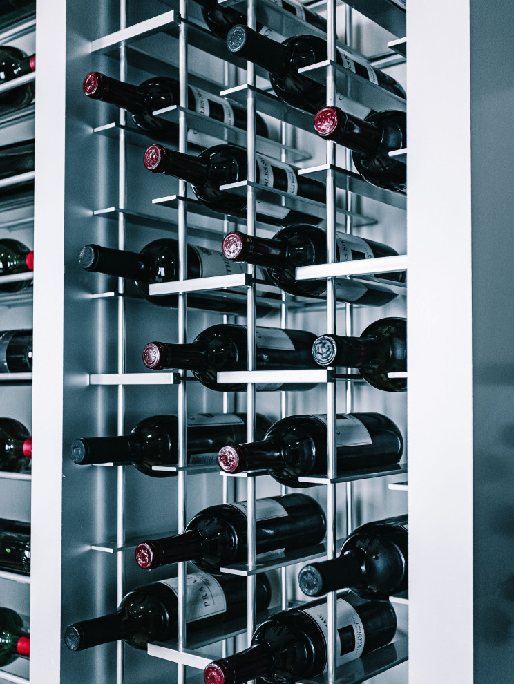 This is an example of a large contemporary wine cellar in San Diego with storage racks.
