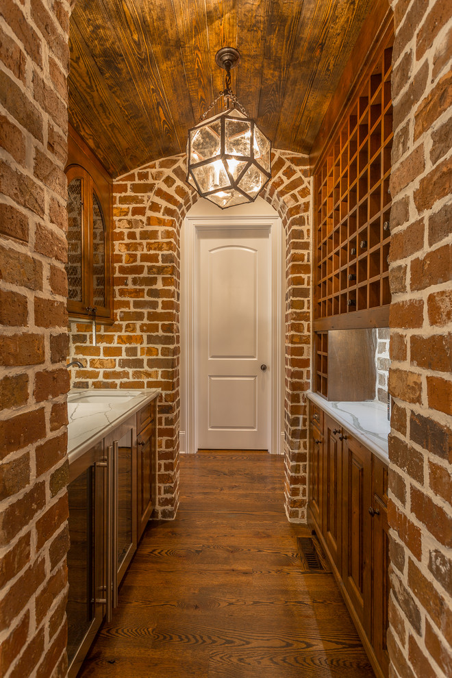 Mid-sized elegant dark wood floor and brown floor wine cellar photo in Other with storage racks
