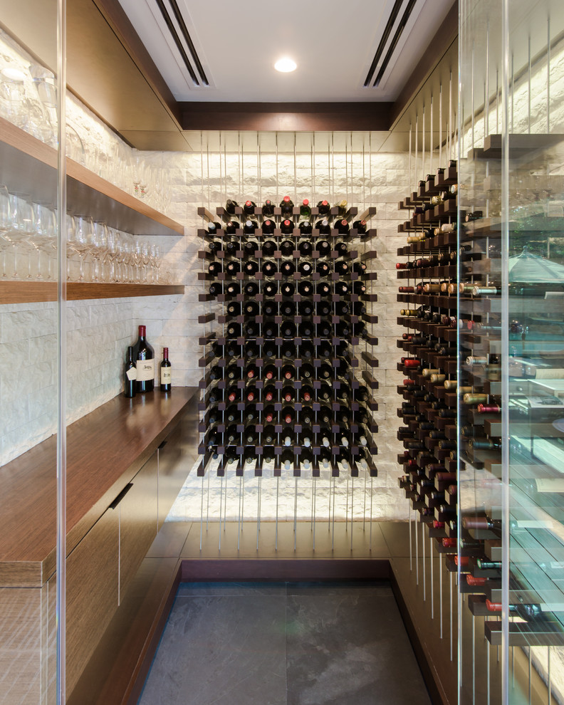 Inspiration for a small contemporary slate floor and gray floor wine cellar remodel in Los Angeles with storage racks