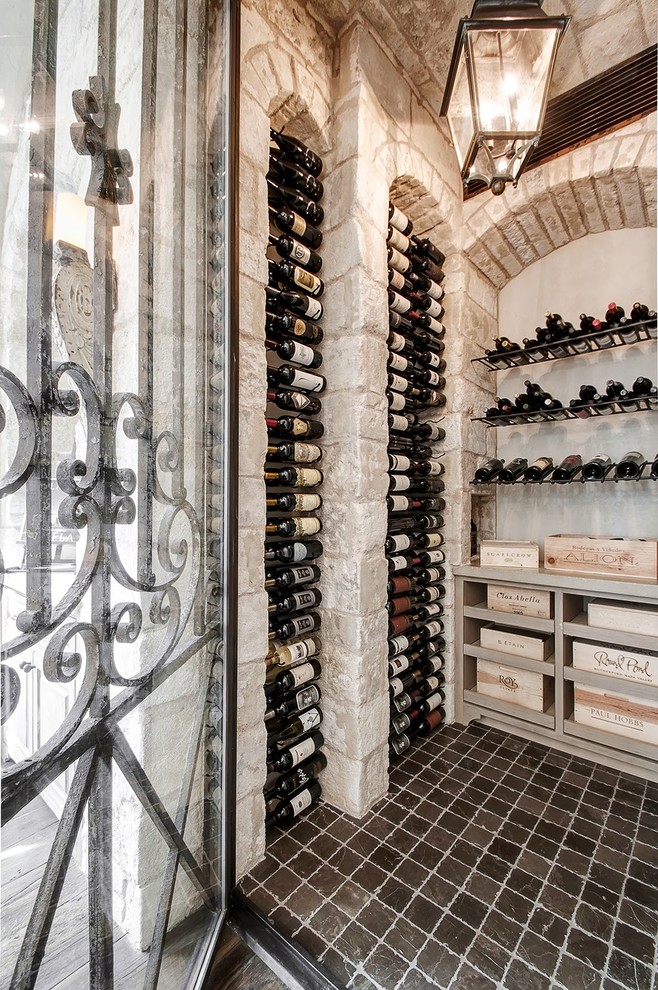Photo of a mediterranean wine cellar in Houston with display racks.