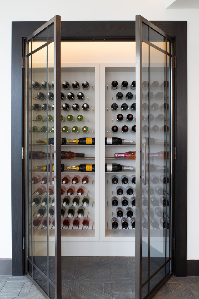 Contemporary wine cellar in Los Angeles with storage racks and brown floors.