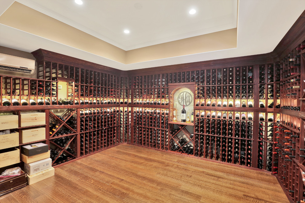 Inspiration for an expansive classic wine cellar in Richmond with medium hardwood flooring and display racks.