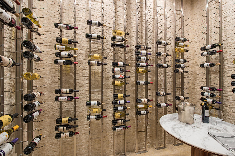 Inspiration for an expansive classic wine cellar in Miami with travertine flooring and storage racks.