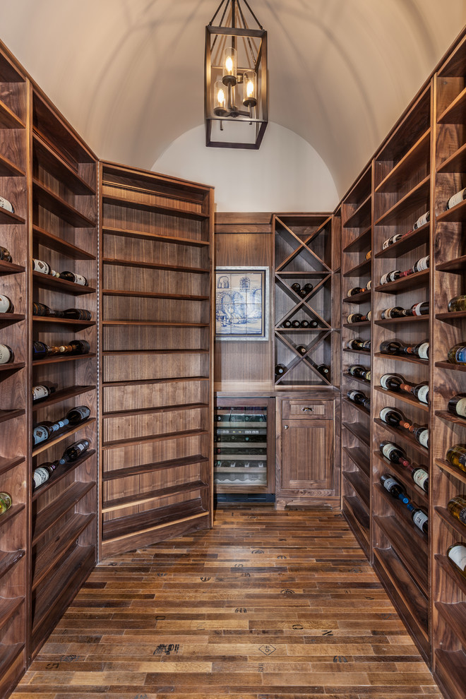 Example of a classic cork floor wine cellar design in Other with storage racks