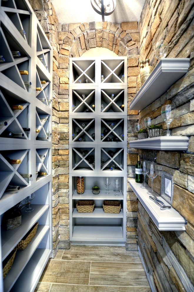 Photo of a small mediterranean wine cellar in Tampa with cube storage.