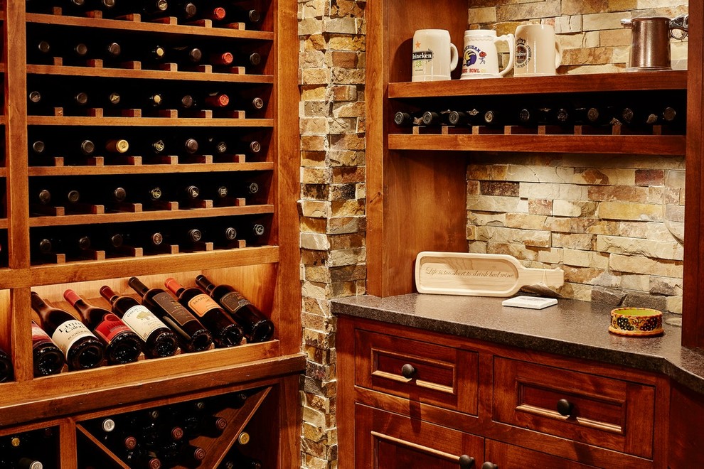 Wine cellar - large traditional slate floor and gray floor wine cellar idea in Minneapolis with display racks