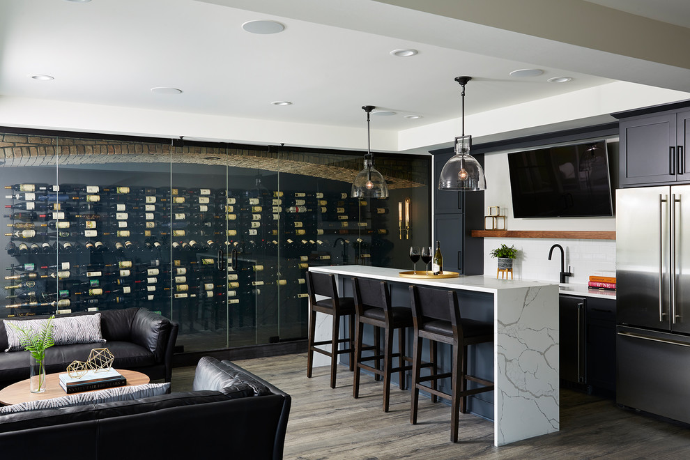 This is an example of an expansive modern wine cellar in Minneapolis with vinyl flooring, display racks and black floors.