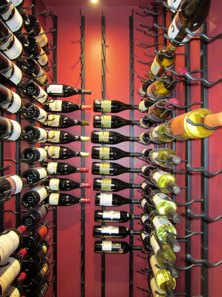 Example of a small trendy wine cellar design in Dallas with storage racks