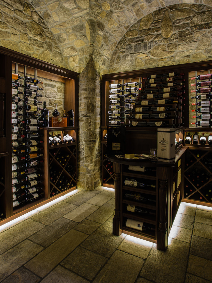 Wine cellar - mediterranean slate floor wine cellar idea in Other with diamond bins