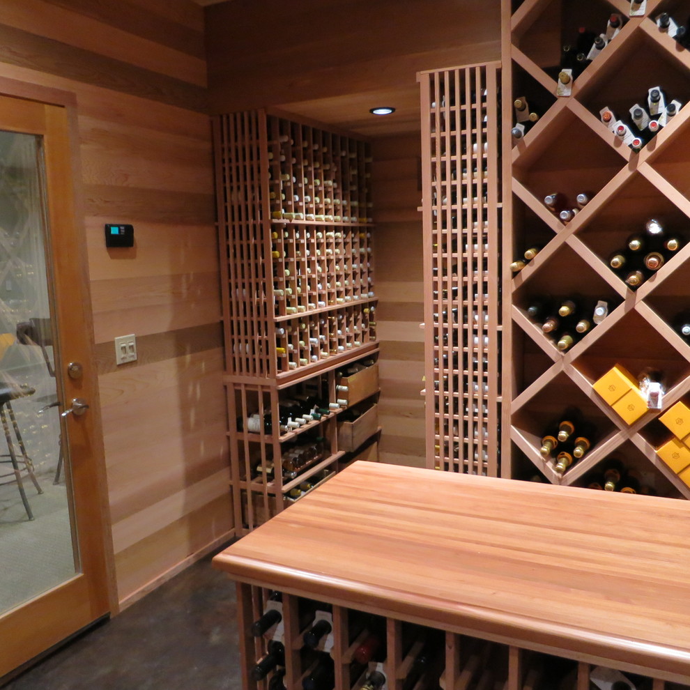 Inspiration for an expansive traditional wine cellar in Burlington with concrete flooring and storage racks.