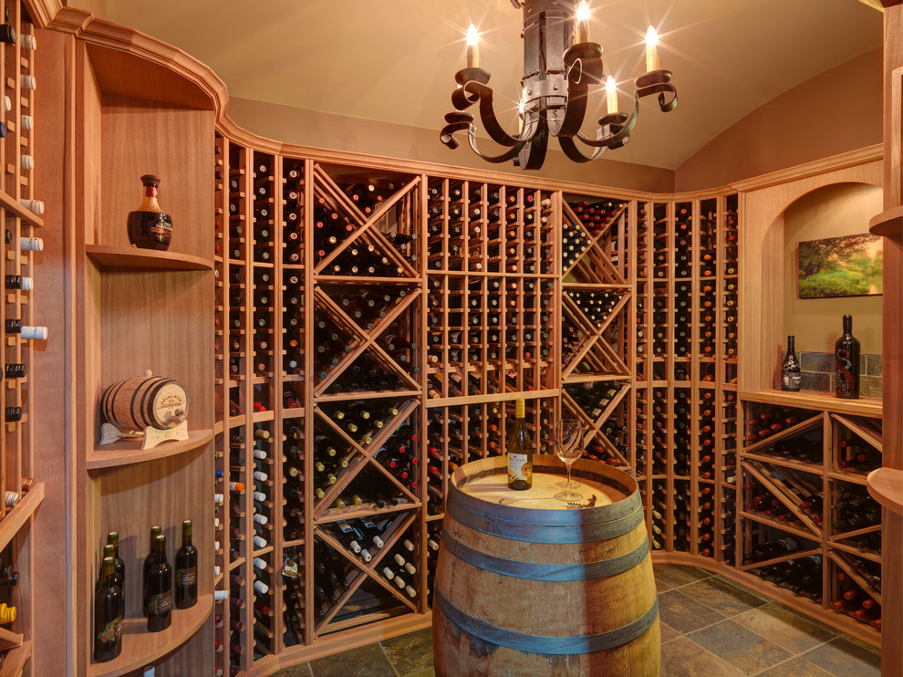 This is an example of a medium sized traditional wine cellar in Vancouver with slate flooring, storage racks and brown floors.