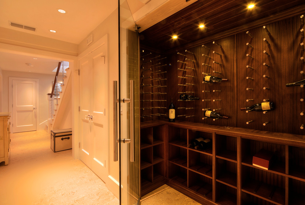 Inspiration for a mid-sized craftsman limestone floor and beige floor wine cellar remodel in Providence with display racks