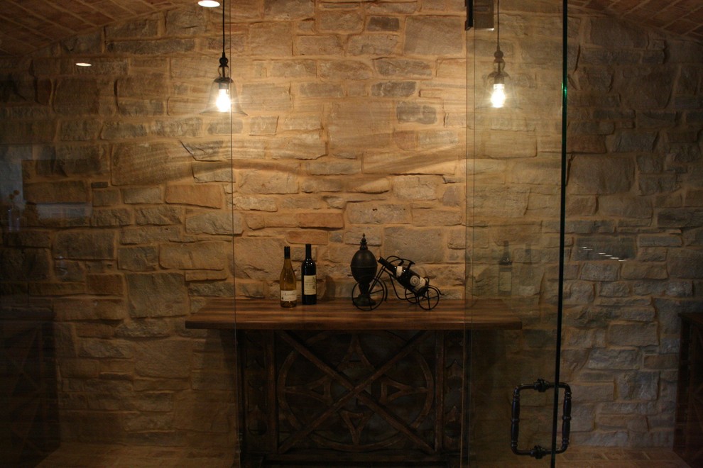 Medium sized mediterranean wine cellar in Other with brick flooring and storage racks.