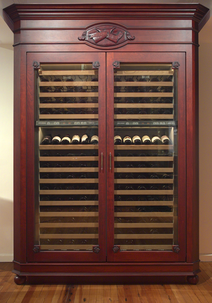 Cette image montre une cave à vin traditionnelle de taille moyenne avec parquet clair et des casiers.