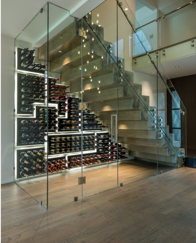 Medium sized modern wine cellar in New York with display racks.
