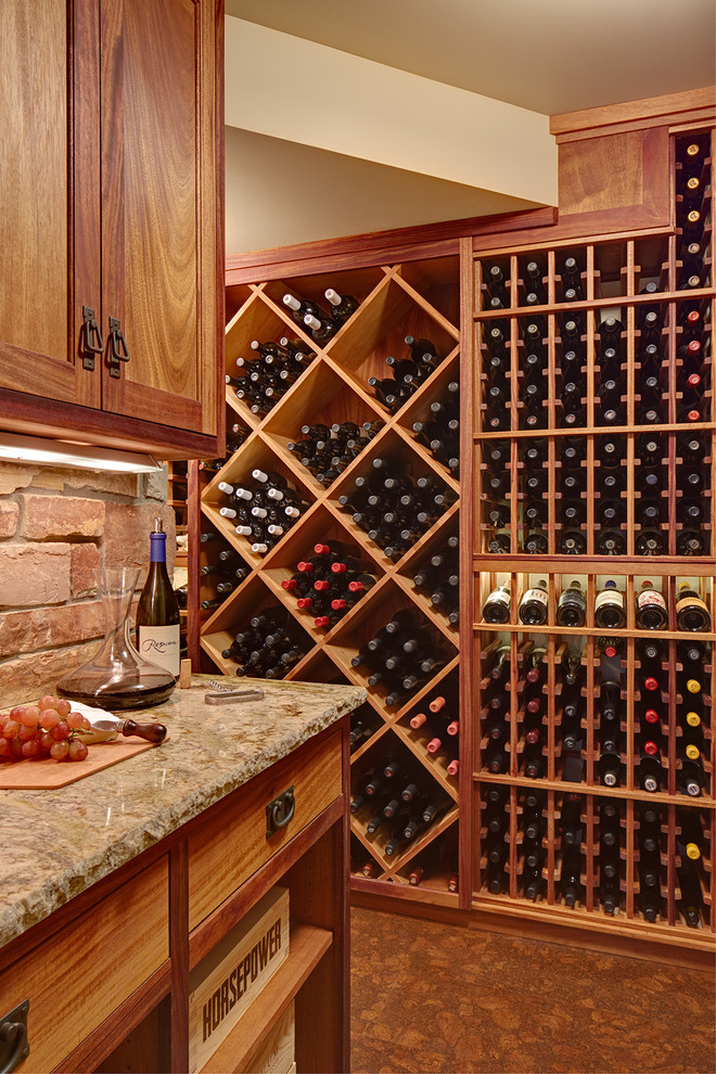 Large rustic wine cellar in Minneapolis with cork flooring, storage racks and brown floors.