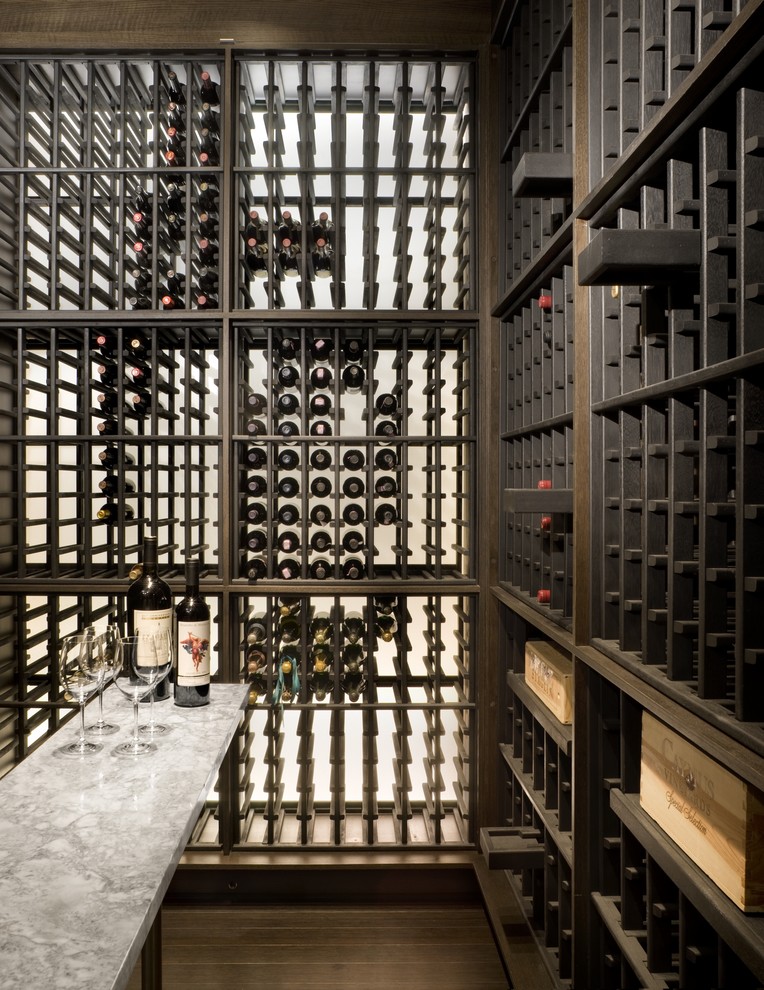 Exemple d'une cave à vin tendance avec parquet foncé, des casiers et un sol marron.
