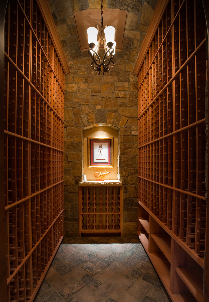 Large rustic wine cellar in Denver with storage racks and brick flooring.