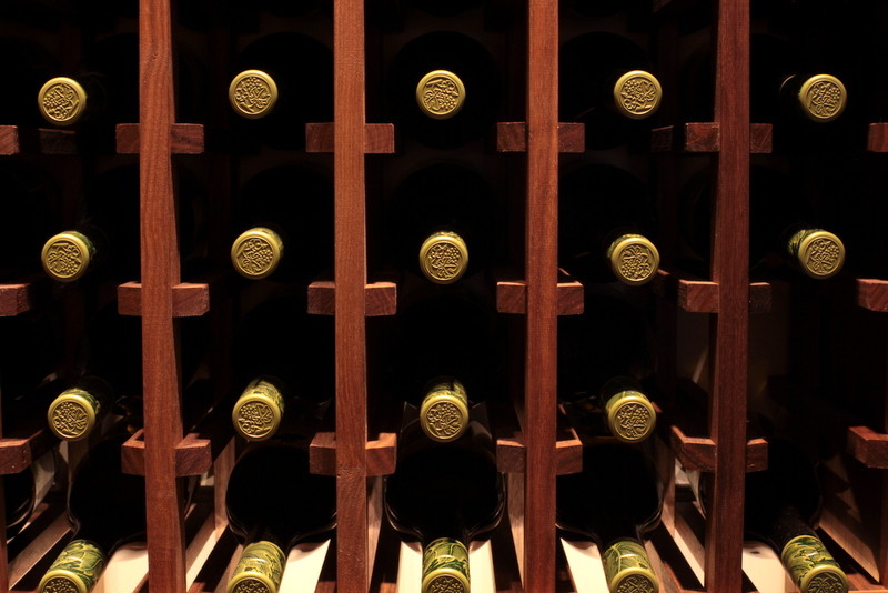 This is an example of a medium sized classic wine cellar in Vancouver with porcelain flooring and storage racks.