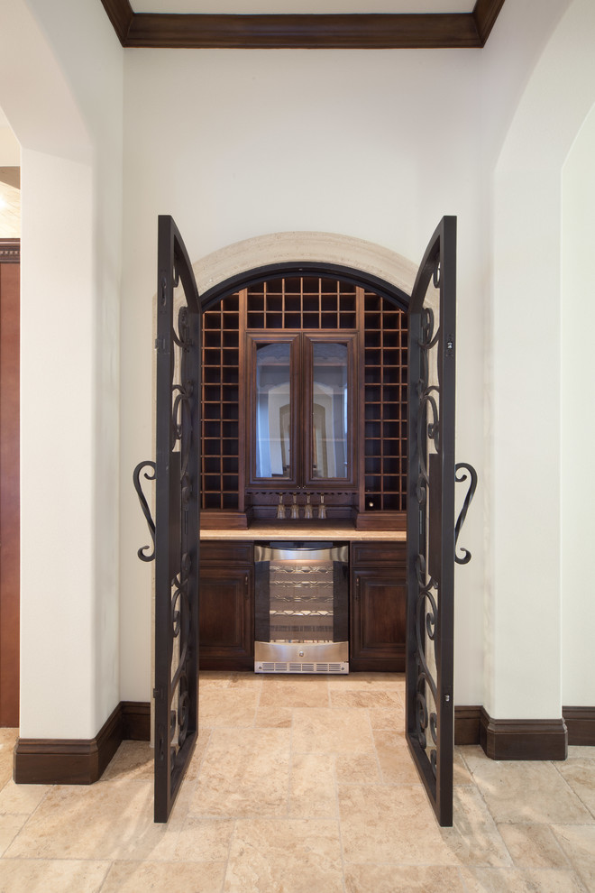 Example of a mid-sized tuscan travertine floor wine cellar design in Orlando with storage racks