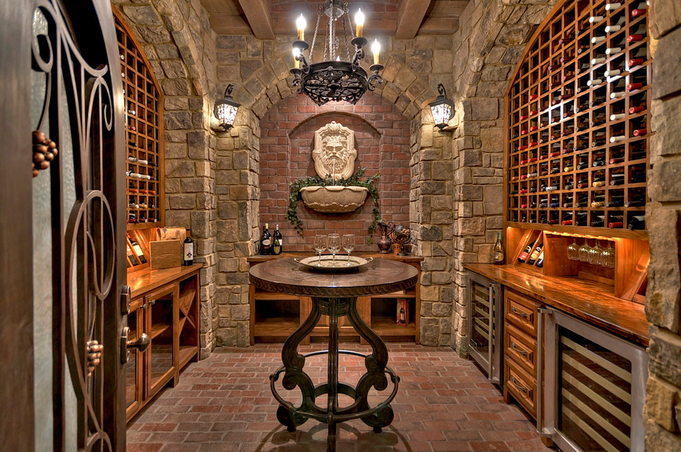 Inspiration for a mediterranean wine cellar in Atlanta with brick flooring and storage racks.