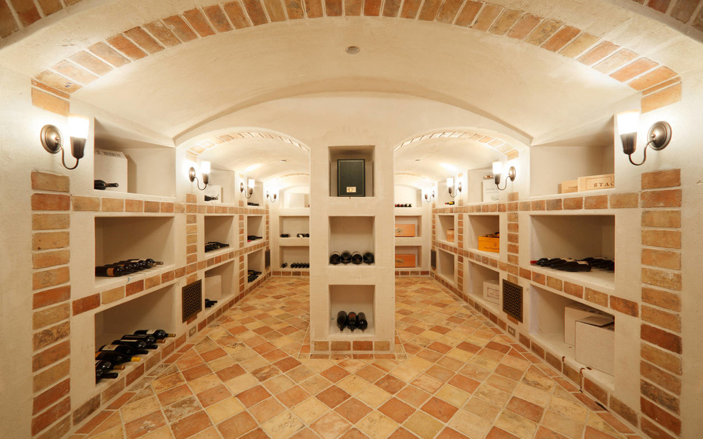 Design ideas for a mediterranean wine cellar in San Francisco with terracotta flooring and yellow floors.