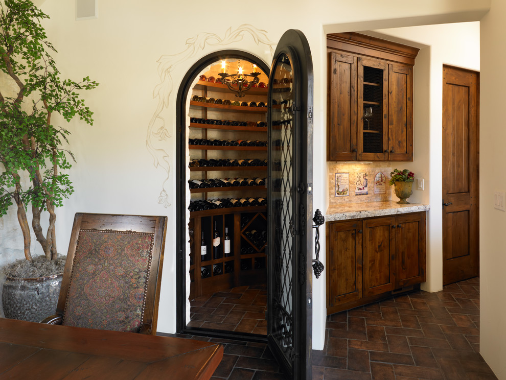 Wine cellar - large mediterranean wine cellar idea in Denver with storage racks