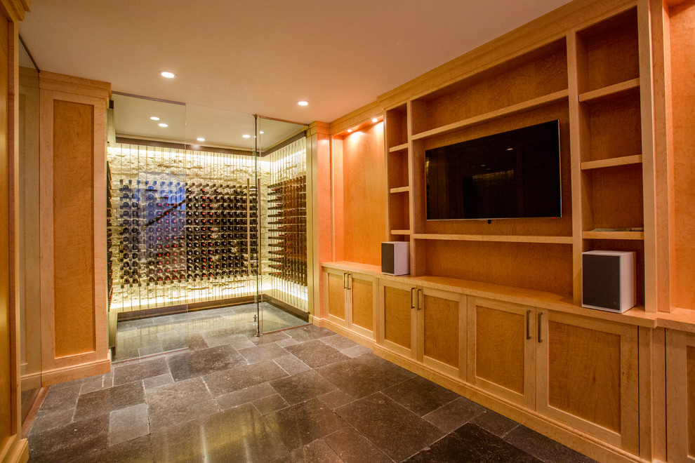 This is an example of a medium sized contemporary wine cellar in Boston with storage racks, travertine flooring and grey floors.