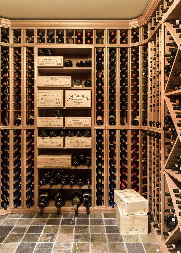 Wine cellar - small traditional slate floor wine cellar idea in New York with display racks