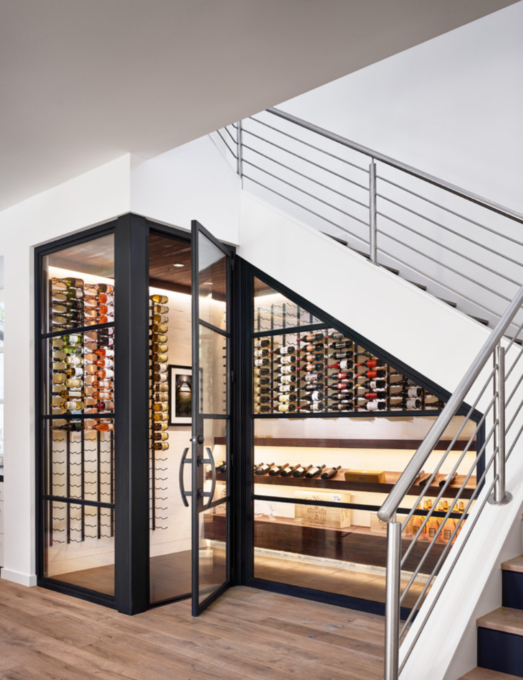 Wine cellar - small contemporary wine cellar idea in Orange County with display racks