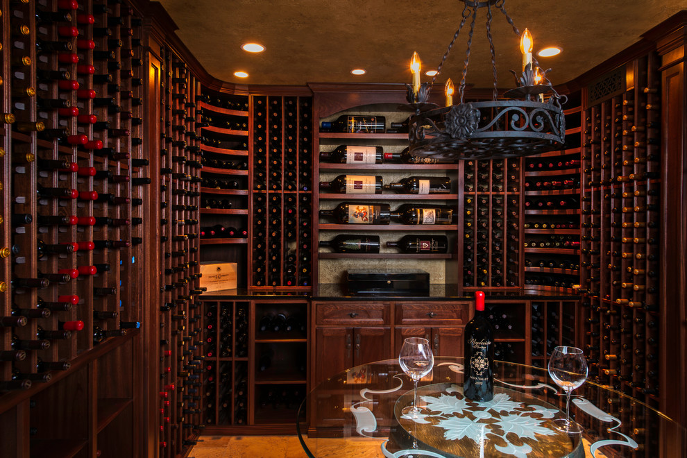 This is an example of a medium sized traditional wine cellar in DC Metro with limestone flooring, storage racks and beige floors.