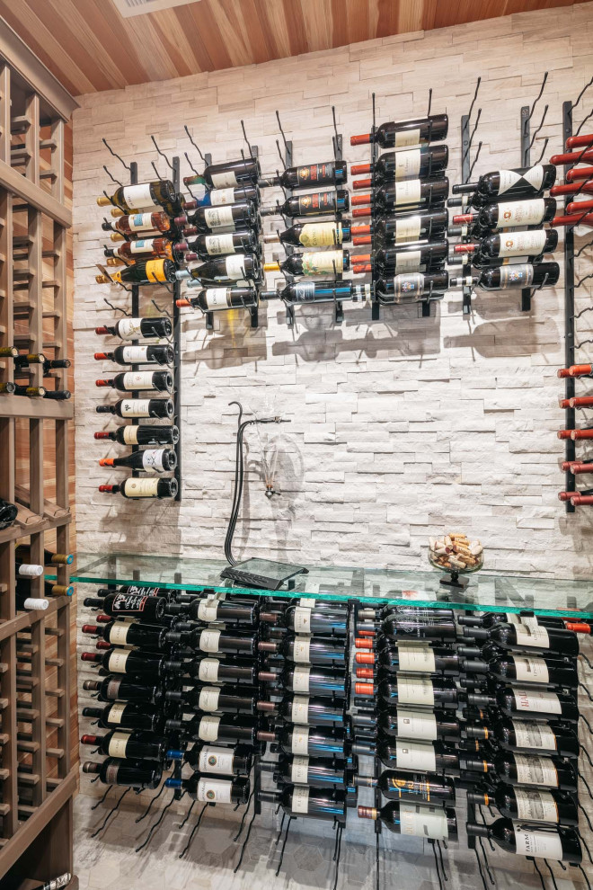 Photo of a midcentury wine cellar in Houston with a feature wall.