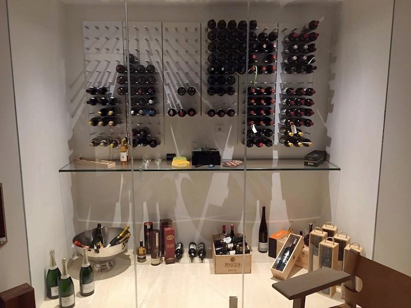 This is an example of an expansive modern wine cellar in San Francisco with storage racks.