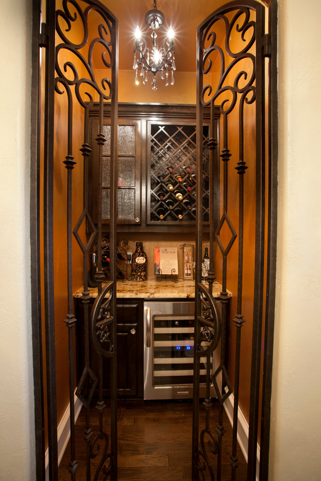 Inspiration for a small mediterranean medium tone wood floor wine cellar remodel in Austin with storage racks