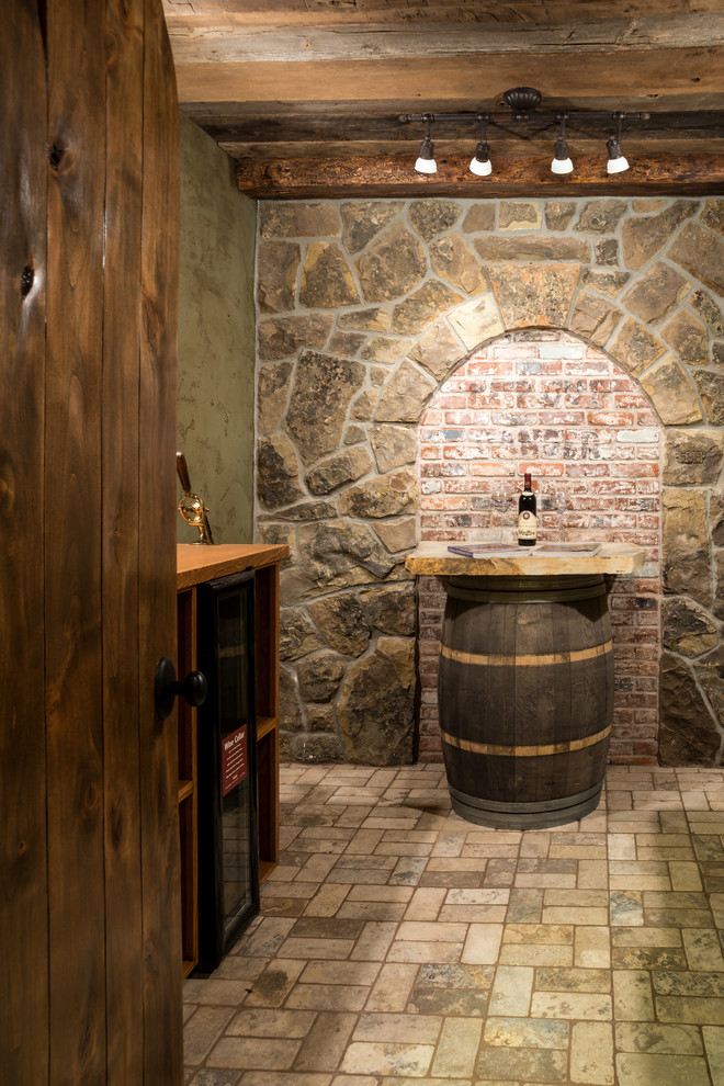 Inspiration for a mid-sized rustic travertine floor wine cellar remodel in Other with display racks