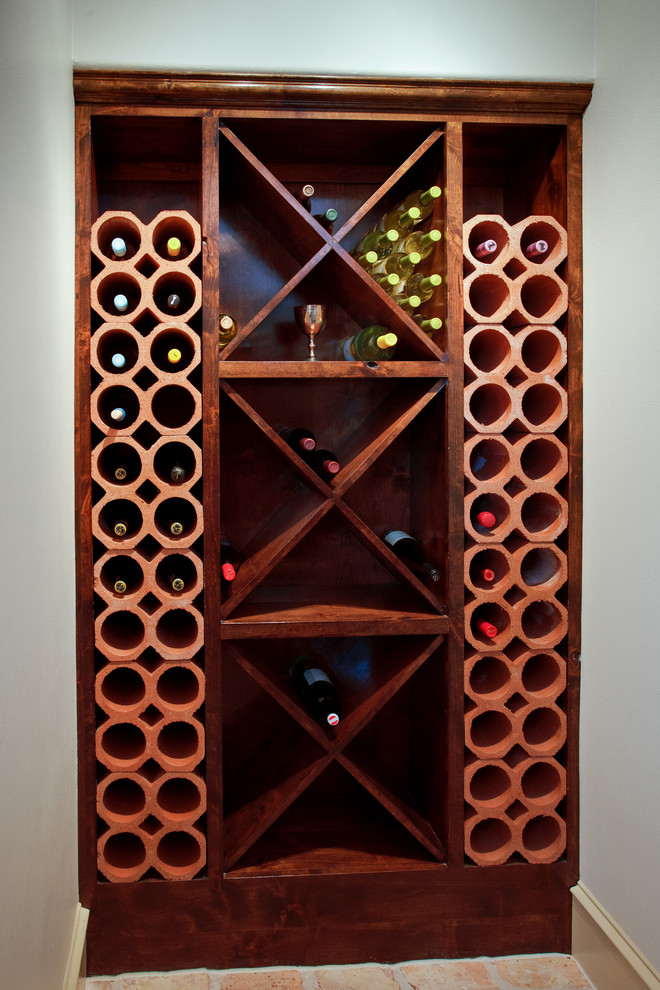 Medium sized traditional wine cellar in Little Rock with ceramic flooring, cube storage and beige floors.