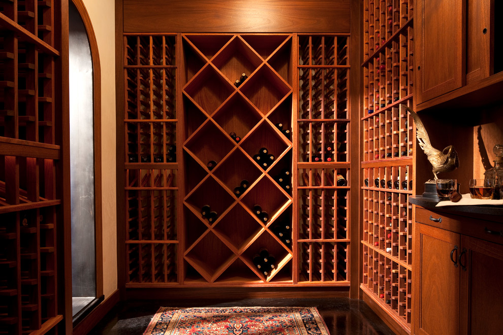 Example of a mid-sized tuscan concrete floor wine cellar design in Minneapolis with diamond bins