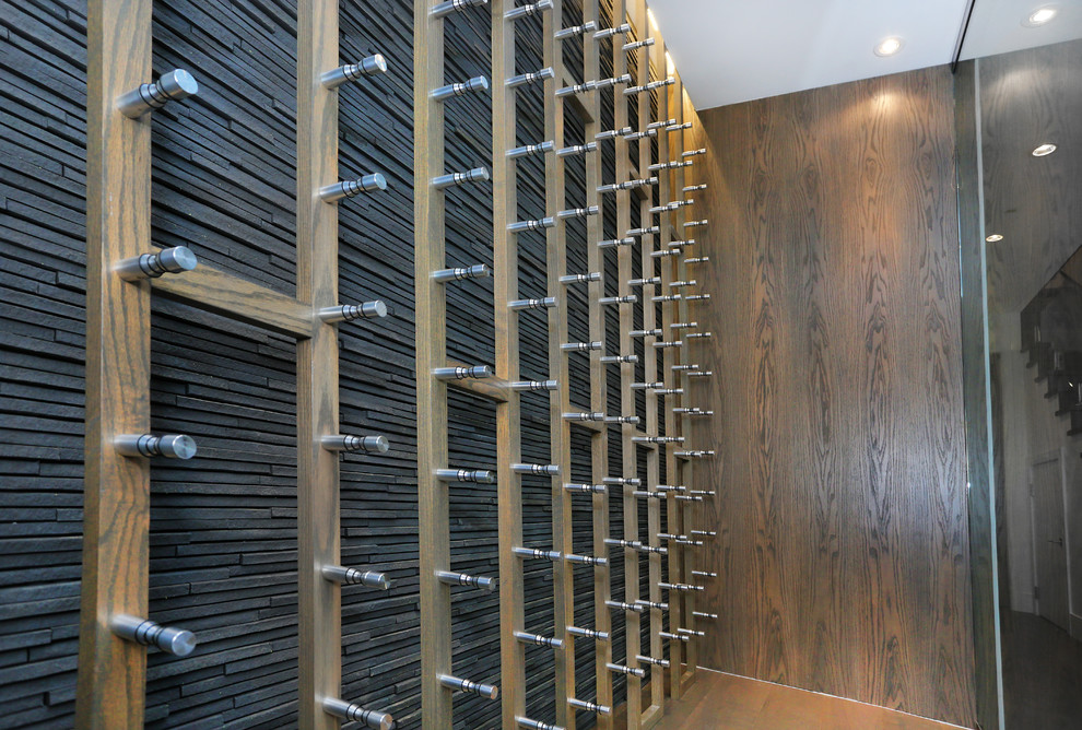Inspiration for an expansive contemporary wine cellar in Vancouver with light hardwood flooring and beige floors.
