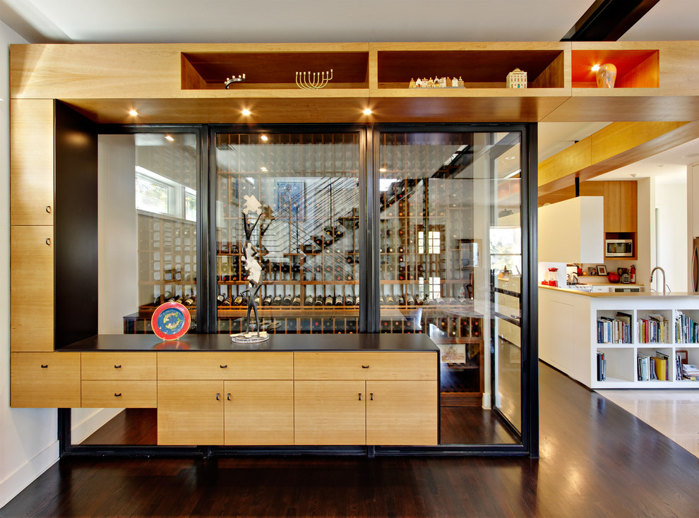 Example of a small minimalist dark wood floor and brown floor wine cellar design in Austin with storage racks