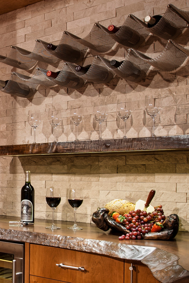 Example of a mid-sized wine cellar design in Denver with storage racks