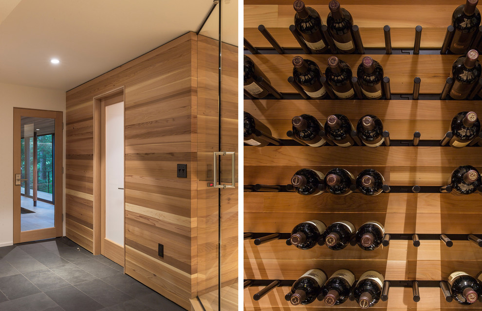 Trendy medium tone wood floor wine cellar photo in Portland with display racks