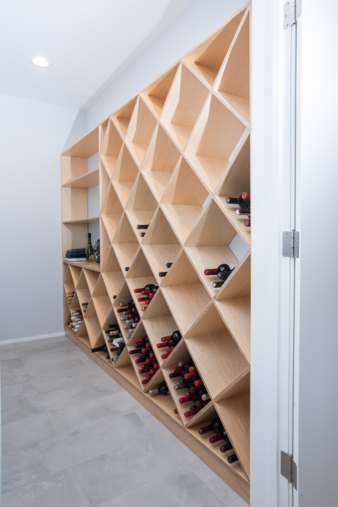 Inspiration for a large contemporary ceramic tile and gray floor wine cellar remodel in Grand Rapids with diamond bins