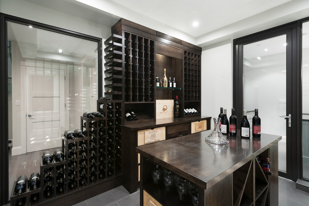 Example of a large transitional wine cellar design in Vancouver with storage racks